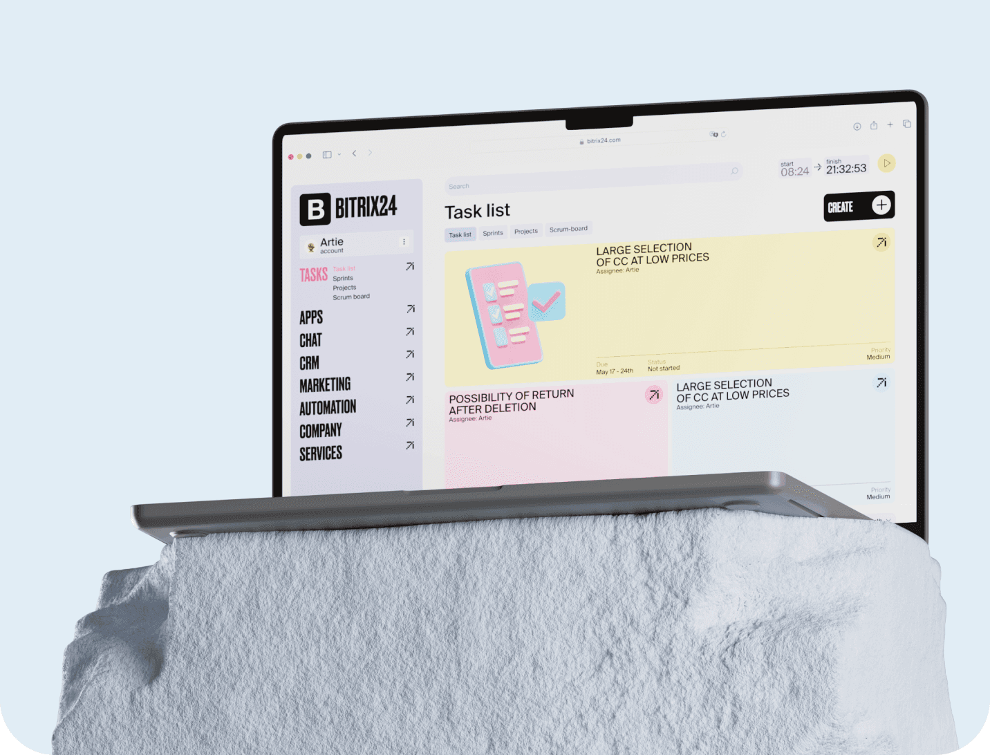 Redesigned Bitrix24 task list on a laptop resting on a white stone