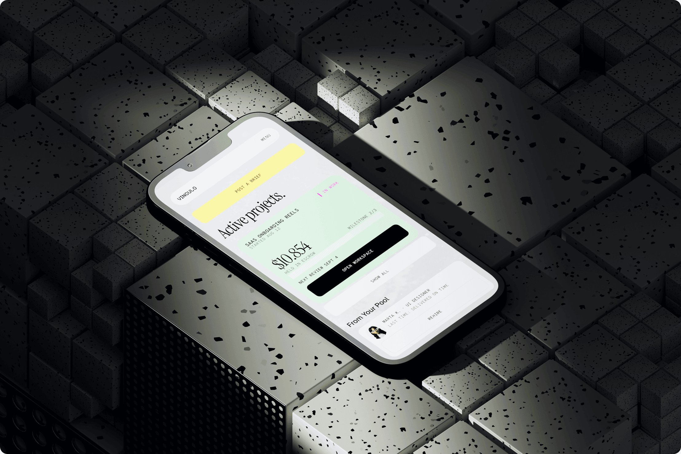 Vinculo Active projects screen on a phone lying on dark concrete blocks