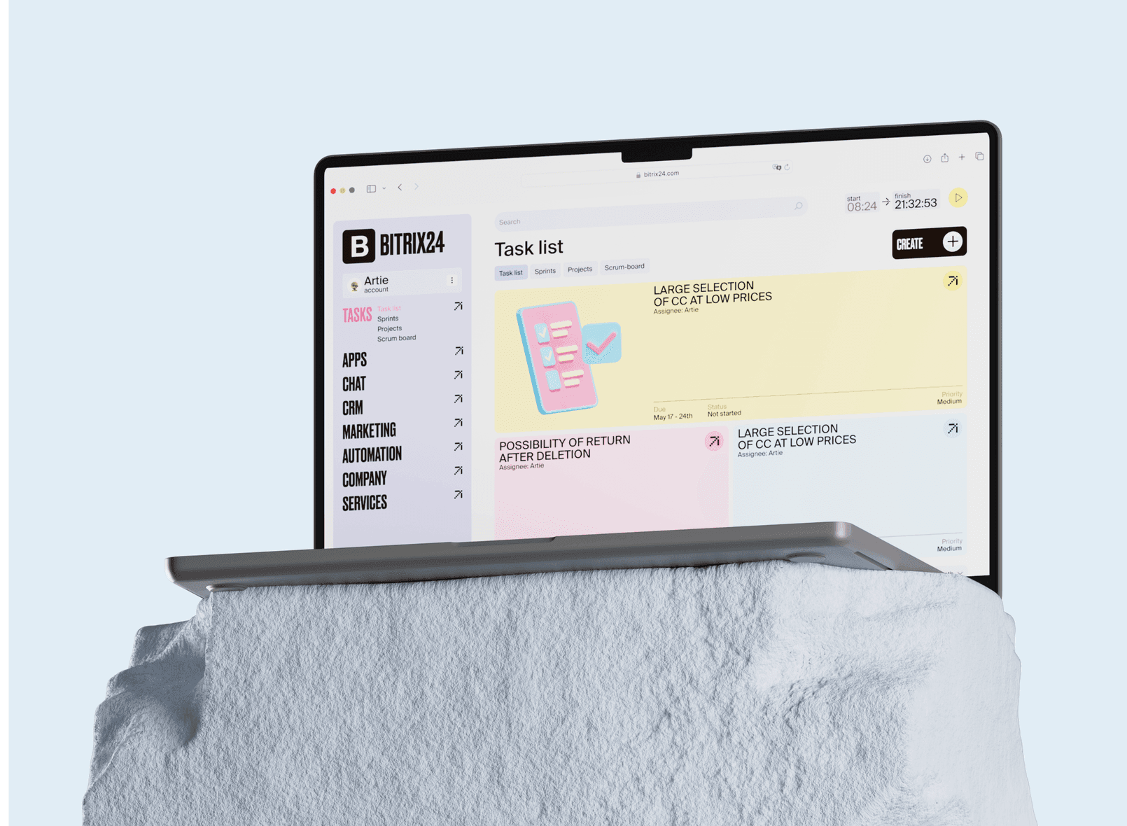 Bitrix24 task list redesign on a laptop resting on a white stone